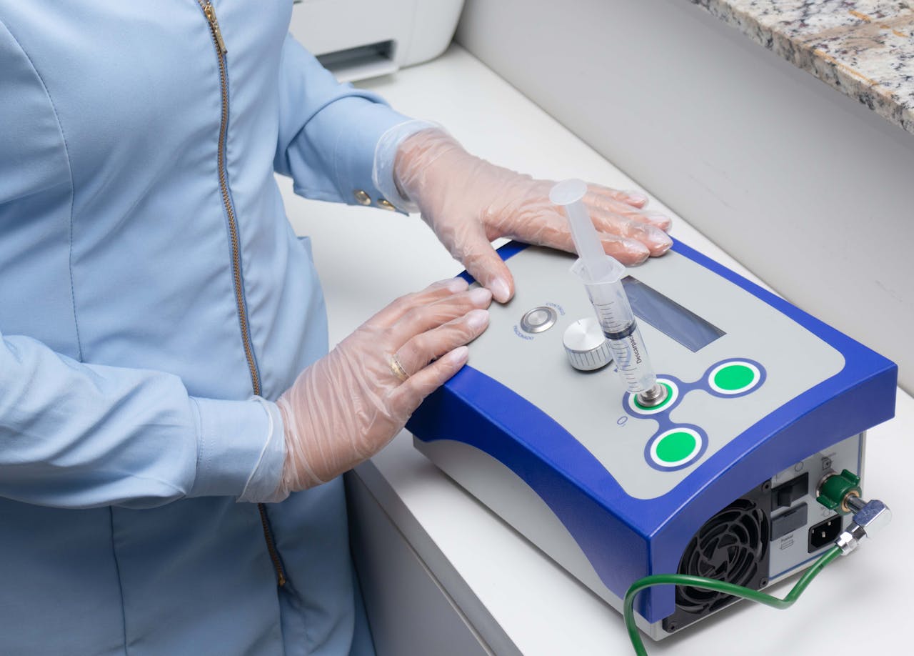 Close-up of a healthcare professional using a medical device in a clinical setting.